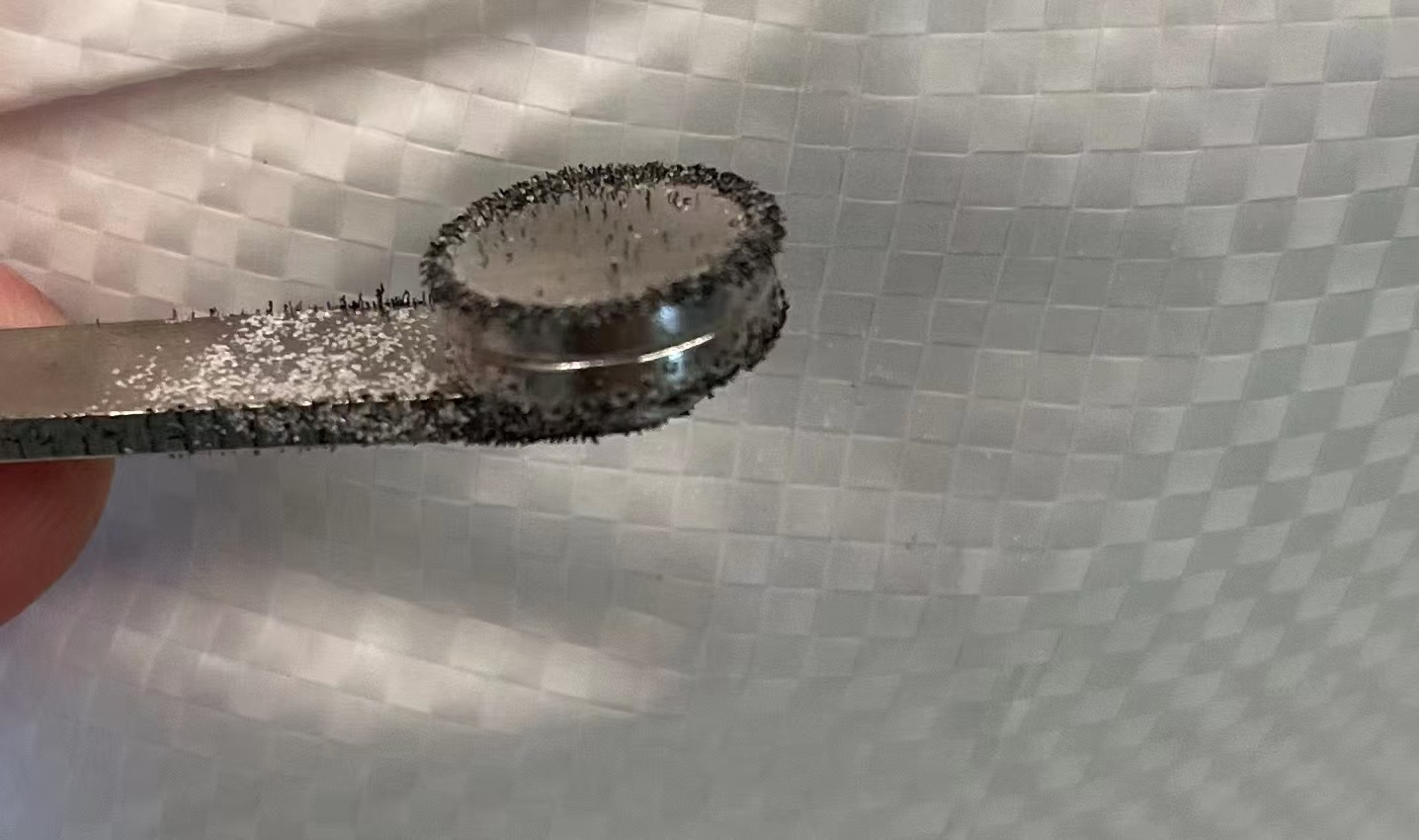 Ferromagnetic particles collected by passing a clean magnet through the fused silica sample.