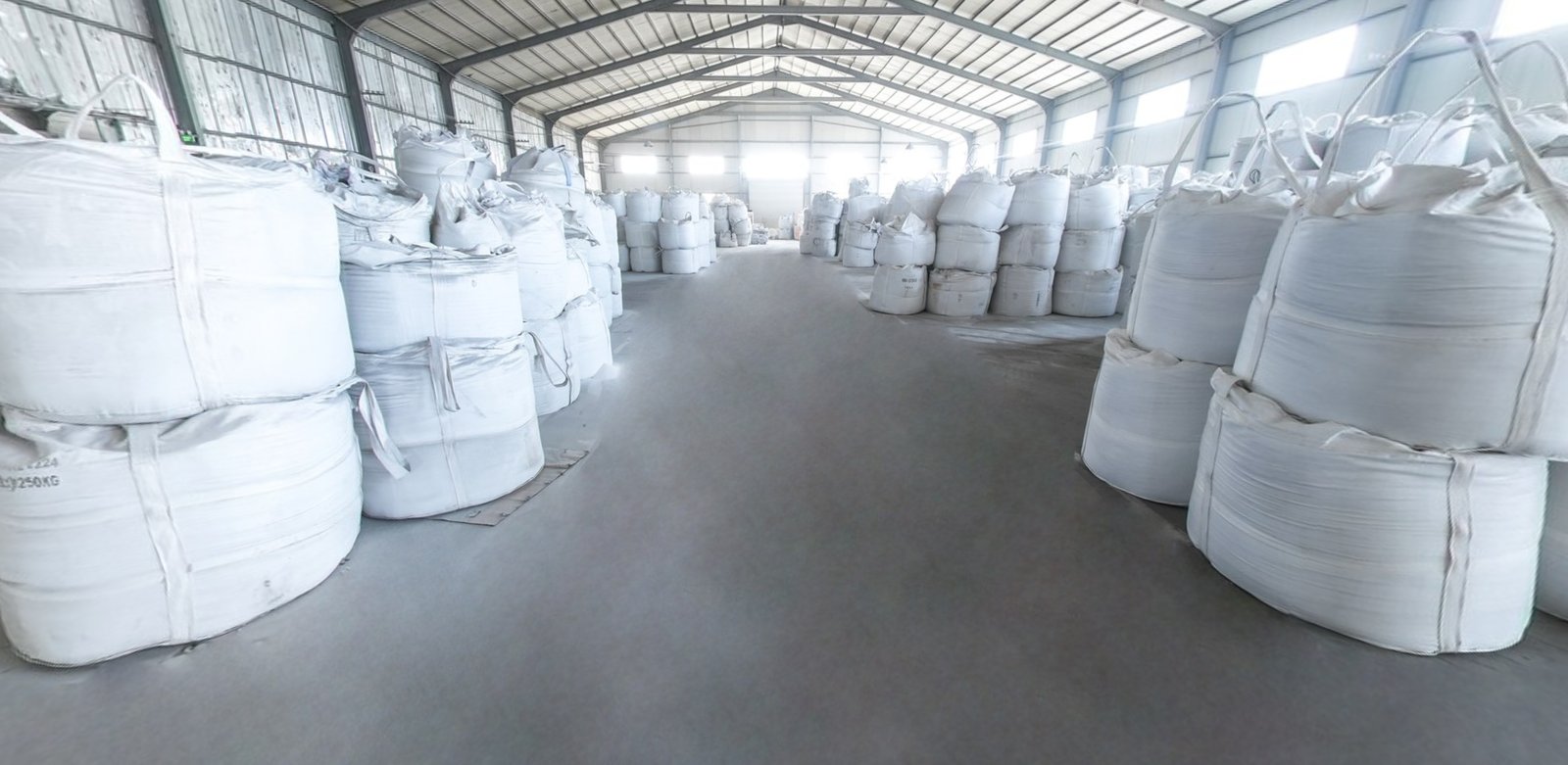 Fused silica grains and powder finished-batch warehouse — palletised 1-ton jumbo bags stored in aisle rows
