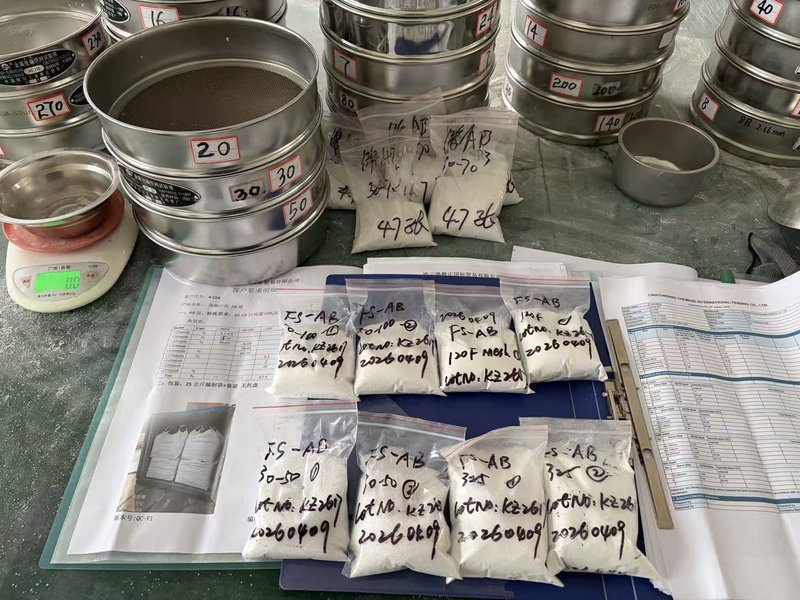 Pre-shipment sampling and COA documentation — bagged FS-AB samples tagged with batch code and date alongside signed COA folder and customer specification sheet at the Chemsize lab