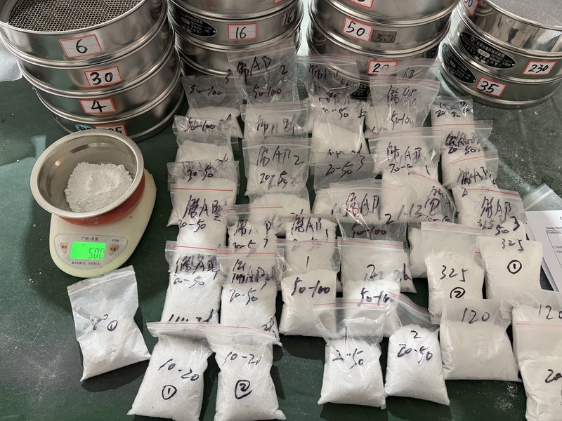 Retained samples and standard test sieves (4/6/16/30/50/100/230 mesh) with precision balance at the Chemsize lab — every batch archived for traceability