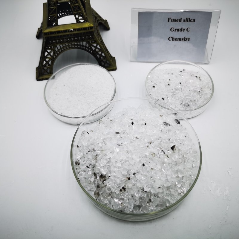 Fused silica Grade C sand — larger black lines or patches; may contain cristobalite pieces (C-/D grade)