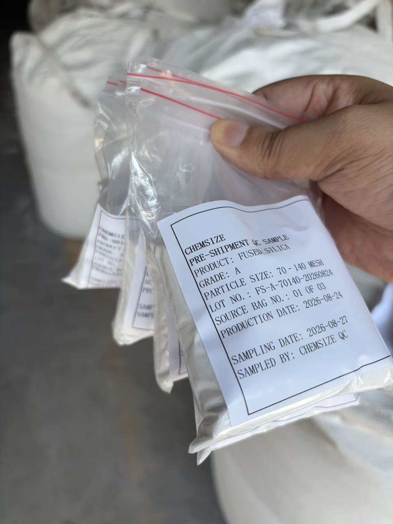 Labelled pre-shipment QC sample of Grade A 70–140 mesh fused silica sand, showing the Chemsize QC label with grade, particle size, lot number, source bag, production date and sampling date.