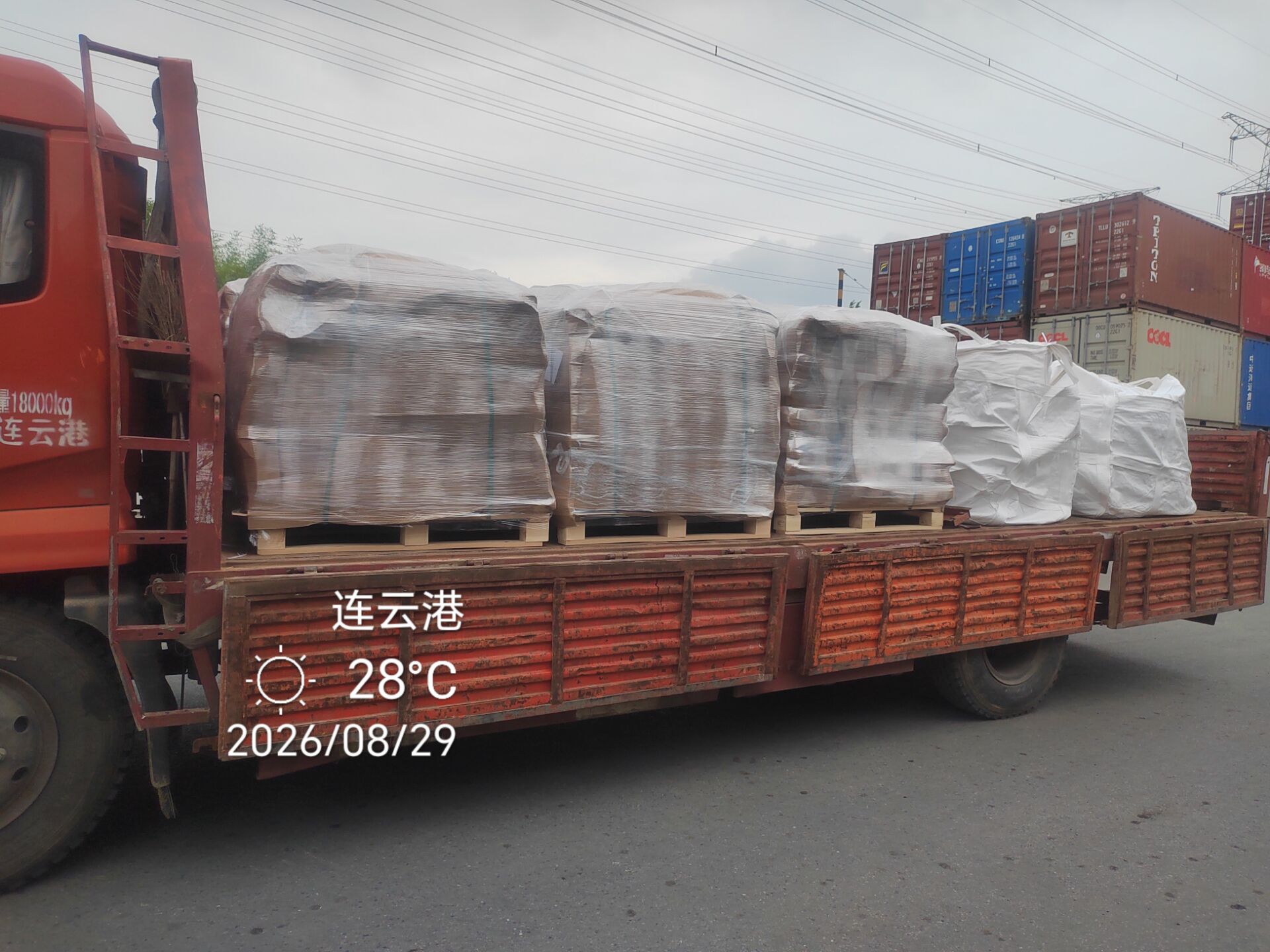 Palletised fused silica products wrapped in stretch film on a flatbed truck in the Lianyungang container terminal, ready for transfer to the export container.
